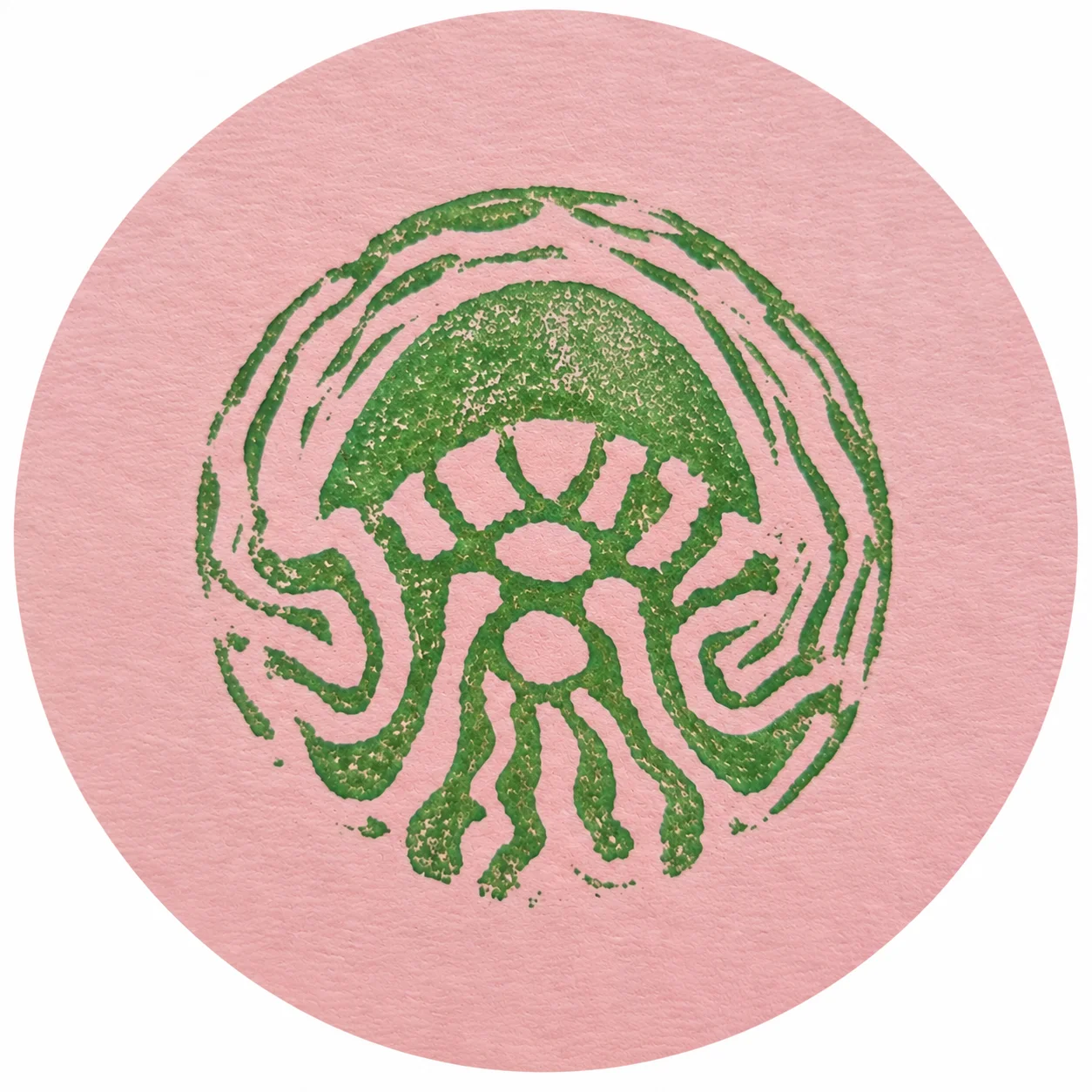 Hand-printed green jellyfish stamp on pink paper
